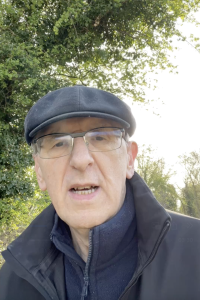 Paul the Dinosaur in a flat cap walking outdoors and reflecting on success after 50 and digital income